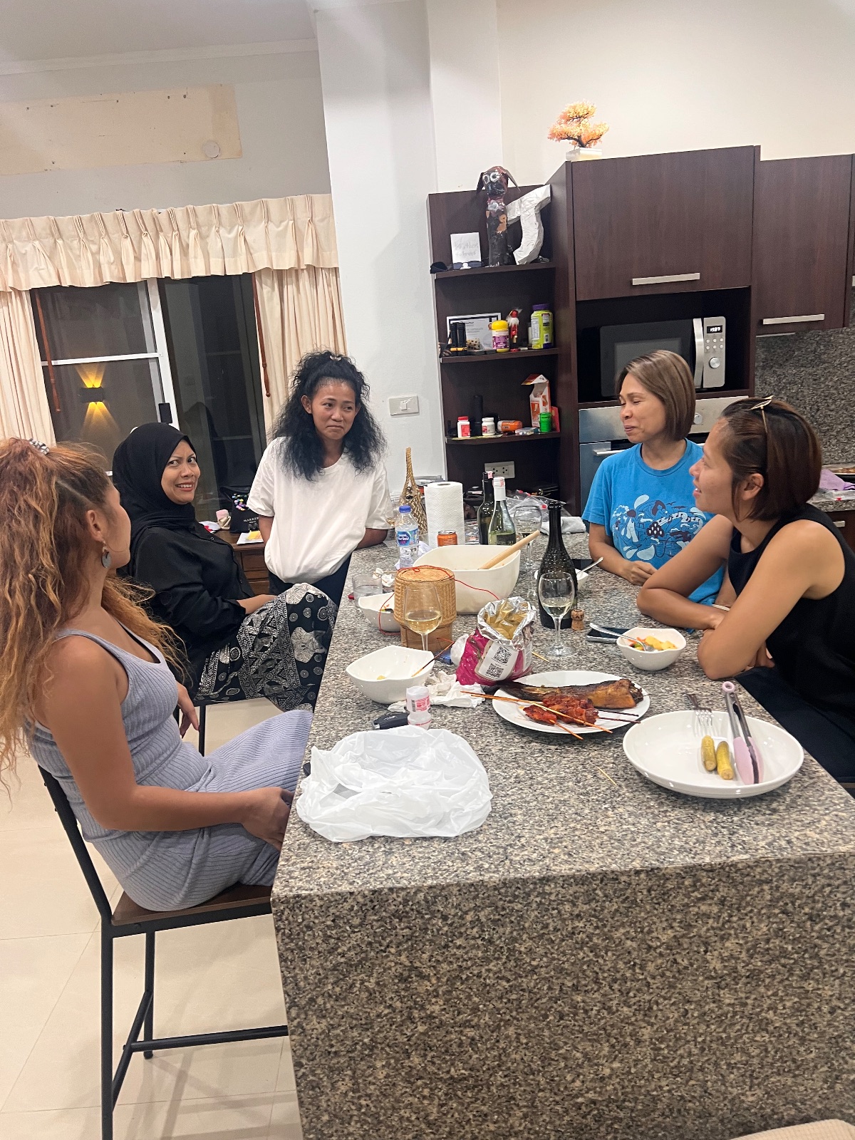 Group gathered around a kitchen island